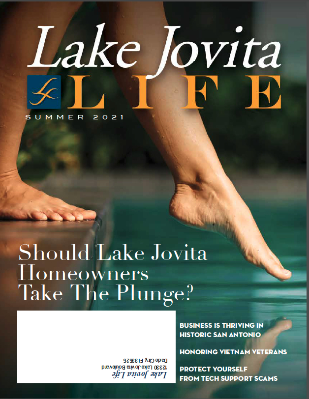 Lake Jovita magazine cover, summer theme, person's feet by water.